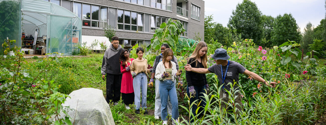 Teacher and students in school's garden